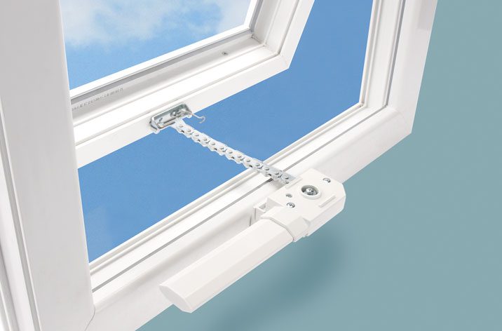 An open white window with a metal chain restrictor and handle, enhanced by window actuators for seamless operation, set against a blue sky background.