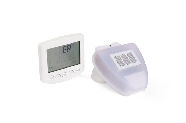 A white electronic medical device with a digital display screen showing "ER" and a separate white handheld sensor with a curved design, ideal for use in environments where door automation enhances workflow efficiency.