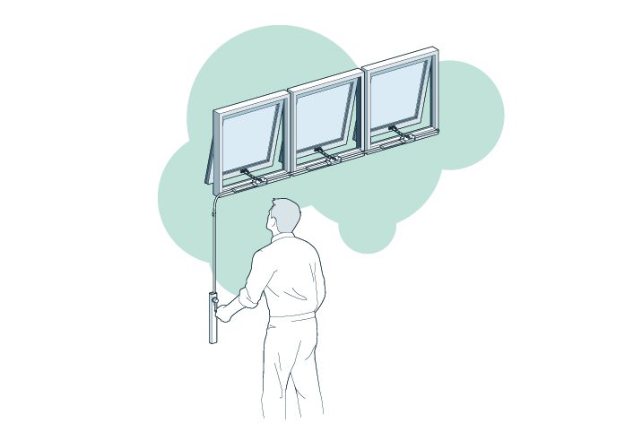 A person standing and operating a device that controls the opening mechanism for a set of three connected windows, ensuring optimal natural ventilation.