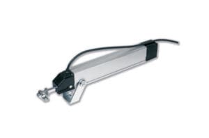 A linear actuator with a metallic body, black end caps, and an attached cable is depicted against a white background, illustrating its potential use in window actuators for improved natural ventilation.