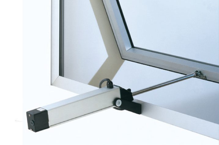 A window with a mechanical actuator arm opening it. The window is hinged at the top, and the actuator is attached to the bottom frame, providing efficient natural ventilation.