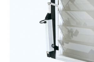 A close-up shows a mechanism connected to horizontal louvered window panels, possibly a motor for opening and closing the louvers, enhancing natural ventilation.