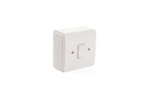 A white plastic wall-mounted light switch with a single toggle in the center, seamlessly integrating with advanced door automation systems.