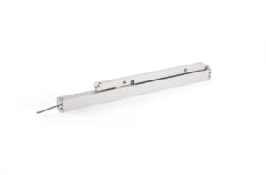 A linear actuator with a silver metallic finish, featuring a slim rectangular design and a protruding wire on one end, laid against a white background—perfect for door automation or window actuators.