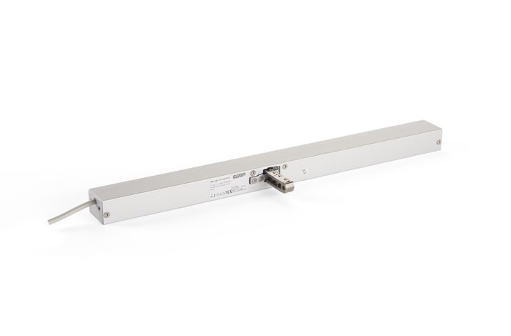 A rectangular metallic linear encoder with a cable extending from one end and a connector in the center, designed to seamlessly integrate with window actuators for efficient natural ventilation.